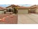 Charming single-Gathering home with a terracotta roof, desert landscaping, and stone accents at 1011 E Amberwood Dr, Phoenix, AZ 85048