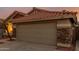Close up of the single-Gathering home with a terracotta roof and a garage at 1011 E Amberwood Dr, Phoenix, AZ 85048