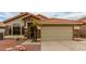 Close up of the single-Gathering home with a terracotta roof, desert landscaping, and stone accents at 1011 E Amberwood Dr, Phoenix, AZ 85048