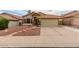 Charming single-Gathering home with a terracotta roof, desert landscaping, and stone accents at 1011 E Amberwood Dr, Phoenix, AZ 85048