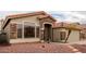 Charming home featuring a stone facade, tile roof, and low-maintenance desert landscaping at 1011 E Amberwood Dr, Phoenix, AZ 85048