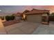 View of the single-Gathering home with a terracotta roof and a long driveway at 1011 E Amberwood Dr, Phoenix, AZ 85048