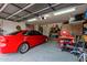 Spacious garage with a car and shelving units along the perimeter at 1011 E Amberwood Dr, Phoenix, AZ 85048