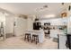 Kitchen featuring a center island with seating, white cabinets, and stainless steel appliances at 1011 E Amberwood Dr, Phoenix, AZ 85048