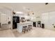 Spacious kitchen boasts white cabinets, black appliances, and a convenient center island with seating at 1011 E Amberwood Dr, Phoenix, AZ 85048