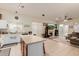 Open kitchen with a center island, white cabinets, and stainless steel appliances at 1011 E Amberwood Dr, Phoenix, AZ 85048