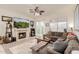 Comfortable living room featuring a fireplace, ceiling fan, and sliding door access at 1011 E Amberwood Dr, Phoenix, AZ 85048