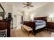 Relaxing main bedroom features a dark wood bed frame, dresser, and access to a spacious walk-in closet at 1011 E Amberwood Dr, Phoenix, AZ 85048