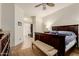 Inviting main bedroom featuring a dark wood bed frame, dresser, and access to a large walk-in closet at 1011 E Amberwood Dr, Phoenix, AZ 85048