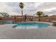 Stunning pool view with rock detail and a serene waterfall, creating the perfect backyard retreat at 1011 E Amberwood Dr, Phoenix, AZ 85048