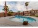Gorgeous backyard pool with rock detail and a serene waterfall, creating the perfect backyard retreat at 1011 E Amberwood Dr, Phoenix, AZ 85048