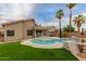 A backyard oasis featuring a pristine pool, lush landscaping, and ample space for relaxation and outdoor entertaining at 1011 E Amberwood Dr, Phoenix, AZ 85048