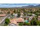 Desert home featuring a swimming pool, lush trees, and a tile roof with mountain views at 10205 E Corrine Dr, Scottsdale, AZ 85260
