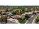 Expansive desert home with a private pool, lush landscaping, and a circular driveway at 10205 E Corrine Dr, Scottsdale, AZ 85260