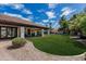 Large backyard featuring lush lawn, mature trees, patio, and a playset at 10205 E Corrine Dr, Scottsdale, AZ 85260