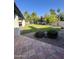 Backyard with landscaping, manicured lawn, tiled patio, and shady trees at 10205 E Corrine Dr, Scottsdale, AZ 85260