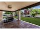 Inviting backyard patio with a ceiling fan, dining table, and view of the playground at 10205 E Corrine Dr, Scottsdale, AZ 85260
