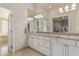 Bathroom showcasing a granite countertop, white cabinets, and double sinks for a luxurious feel at 10205 E Corrine Dr, Scottsdale, AZ 85260