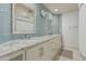Contemporary bathroom with updated blue tiling, dual sinks, and a large mirror with great lighting at 10205 E Corrine Dr, Scottsdale, AZ 85260