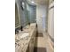 Bathroom featuring granite counters, double sinks, tile backsplash, and tiled flooring at 10205 E Corrine Dr, Scottsdale, AZ 85260