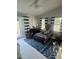 Bedroom features a large window, carpeting, ceiling fan, and matching furniture at 10205 E Corrine Dr, Scottsdale, AZ 85260