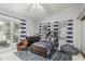 Bedroom decorated with a blue theme, complemented by a large area rug, plush chair, and sliding door at 10205 E Corrine Dr, Scottsdale, AZ 85260