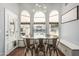 Charming dining area with views of pool, modern lighting, and hardwood floors at 10205 E Corrine Dr, Scottsdale, AZ 85260