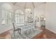 Bright dining room features white wood cathedral ceiling, floors, table and chair set, and decorative chandelier at 10205 E Corrine Dr, Scottsdale, AZ 85260