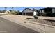 Traditional house with a two-car garage, a basketball hoop, and desert landscaping at 10205 E Corrine Dr, Scottsdale, AZ 85260