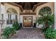 Stunning front entrance with double doors, brick walkway, custom windows and manicured landscaping at 10205 E Corrine Dr, Scottsdale, AZ 85260