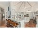 Bright open kitchen features granite counters, bar seating, stainless appliances, and high ceilings at 10205 E Corrine Dr, Scottsdale, AZ 85260