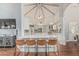 Open-concept kitchen with granite countertops, modern appliances, island seating, and high ceilings at 10205 E Corrine Dr, Scottsdale, AZ 85260