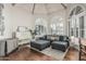 Inviting living room showcasing high ceilings, hardwood floors, plantation shutters, and an open concept design at 10205 E Corrine Dr, Scottsdale, AZ 85260