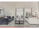 Open living room features hardwood floors, high ceilings, comfortable seating, and access to backyard at 10205 E Corrine Dr, Scottsdale, AZ 85260