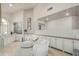 Bright living room with lots of cabinets, comfortable seating, decorative mirrors, and a drink preparation area at 10205 E Corrine Dr, Scottsdale, AZ 85260