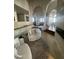 Open-concept living area with decorative columns, hardwood floors, and neutral colors at 10205 E Corrine Dr, Scottsdale, AZ 85260