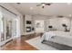 Open main bedroom with hardwood floors, fireplace, French doors, and ensuite bathroom access for optimal convenience at 10205 E Corrine Dr, Scottsdale, AZ 85260