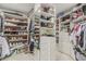 Walk-in closet with ample storage with custom shelving and drawers for optimal organization at 10205 E Corrine Dr, Scottsdale, AZ 85260