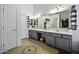 Elegant bathroom features dual sinks, vanity with lots of storage and stylish tile flooring, with decorative accents at 112 E Joseph Way, Gilbert, AZ 85295