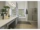 Bright bathroom with dual sinks, decorative accents, large mirrors, a separate shower, and a bathtub at 112 E Joseph Way, Gilbert, AZ 85295