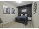 Cozy bedroom with a stylish accent wall, soft lighting, and comfortable furnishings for peaceful nights and relaxation at 112 E Joseph Way, Gilbert, AZ 85295