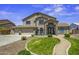 Stunning two-story home with lush green lawn, inviting curb appeal, and convenient three car garage at 112 E Joseph Way, Gilbert, AZ 85295