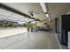 Spacious garage with open door features ample space for parking and storage, equipped with a refrigerator and lighting at 112 E Joseph Way, Gilbert, AZ 85295