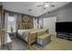 Comfortable main bedroom features neutral decor, wood floors, and a large window, creating a serene and inviting atmosphere at 112 E Joseph Way, Gilbert, AZ 85295