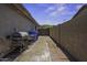 Side yard with brick pavers, a BBQ and room for trash and recycling cans at 112 E Joseph Way, Gilbert, AZ 85295