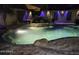 Backyard pool with beautiful rock waterfall feature and decorative lighting at 112 E Joseph Way, Gilbert, AZ 85295