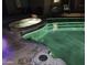 Night view of a well-lit backyard pool and attached spa area at 112 E Joseph Way, Gilbert, AZ 85295