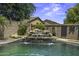 Backyard lagoon style pool with a multi-tiered rock waterfall feature at 112 E Joseph Way, Gilbert, AZ 85295