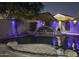 Night view of a luxurious pool with a waterfall feature and stylish blue lighting at 112 E Joseph Way, Gilbert, AZ 85295