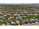 Expansive aerial view of a community with desert landscape and mountain views showcasing many houses with pools at 12727 W Lowden Rd, Peoria, AZ 85383